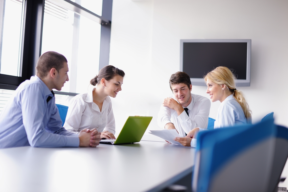 Group of happy young  business people in a meeting at office