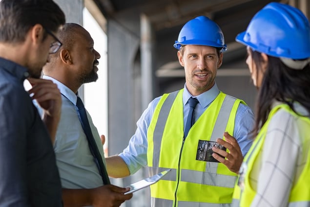 bigstock-Happy-mature-engineer-discussi-345406063